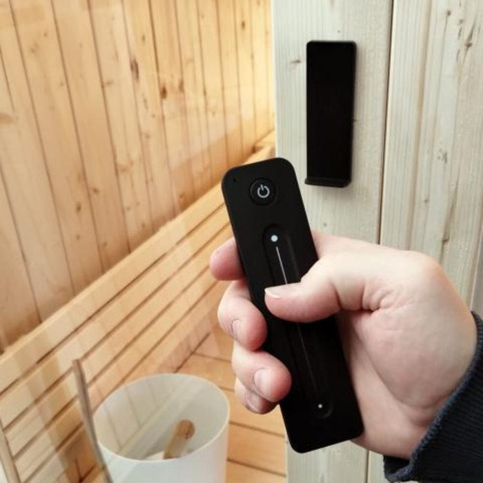 indoor saunas for sale remote in hand