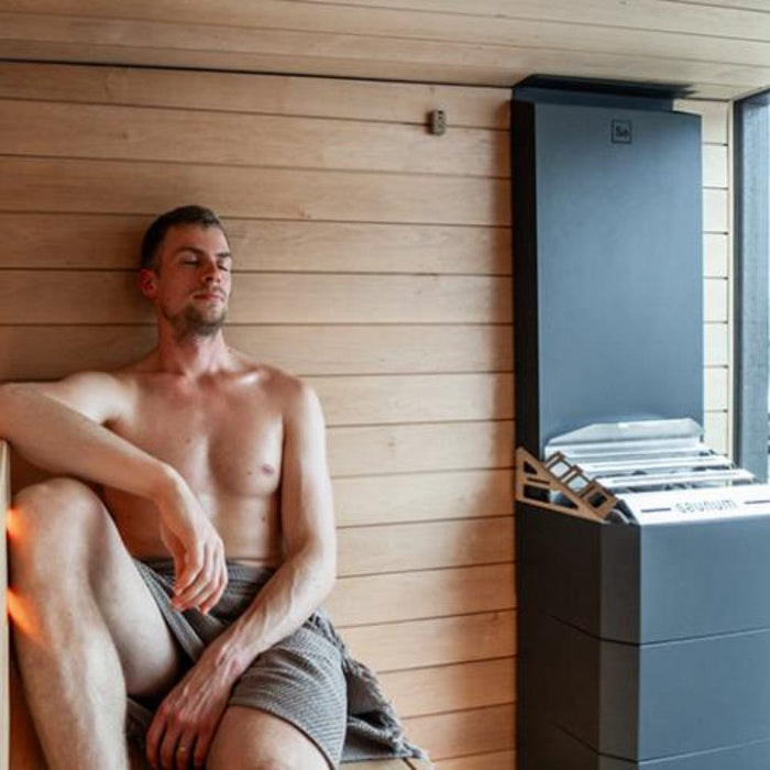 sauna heater for sale with man beside it